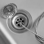 Cleaning,Of,Drain,With,Plumber's,Snake,,Closeup