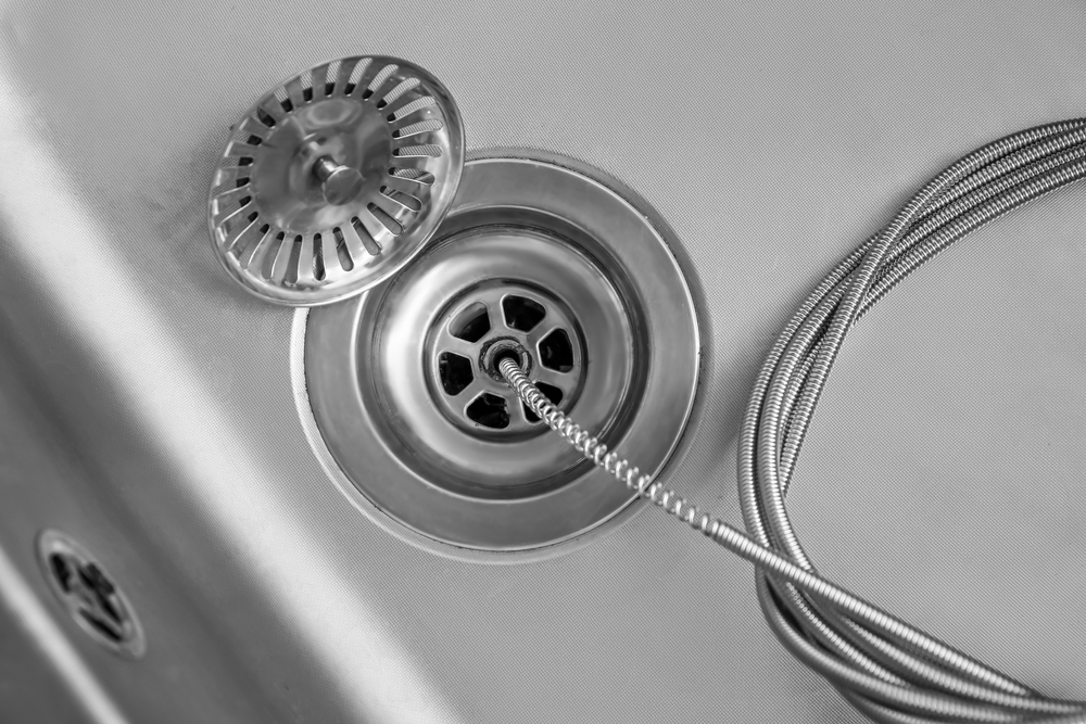 Cleaning,Of,Drain,With,Plumber's,Snake,,Closeup