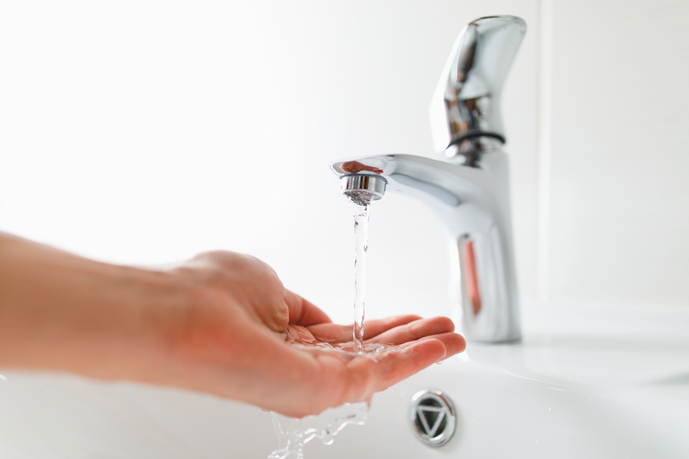 Hand,Under,Faucet,With,Water,Stream